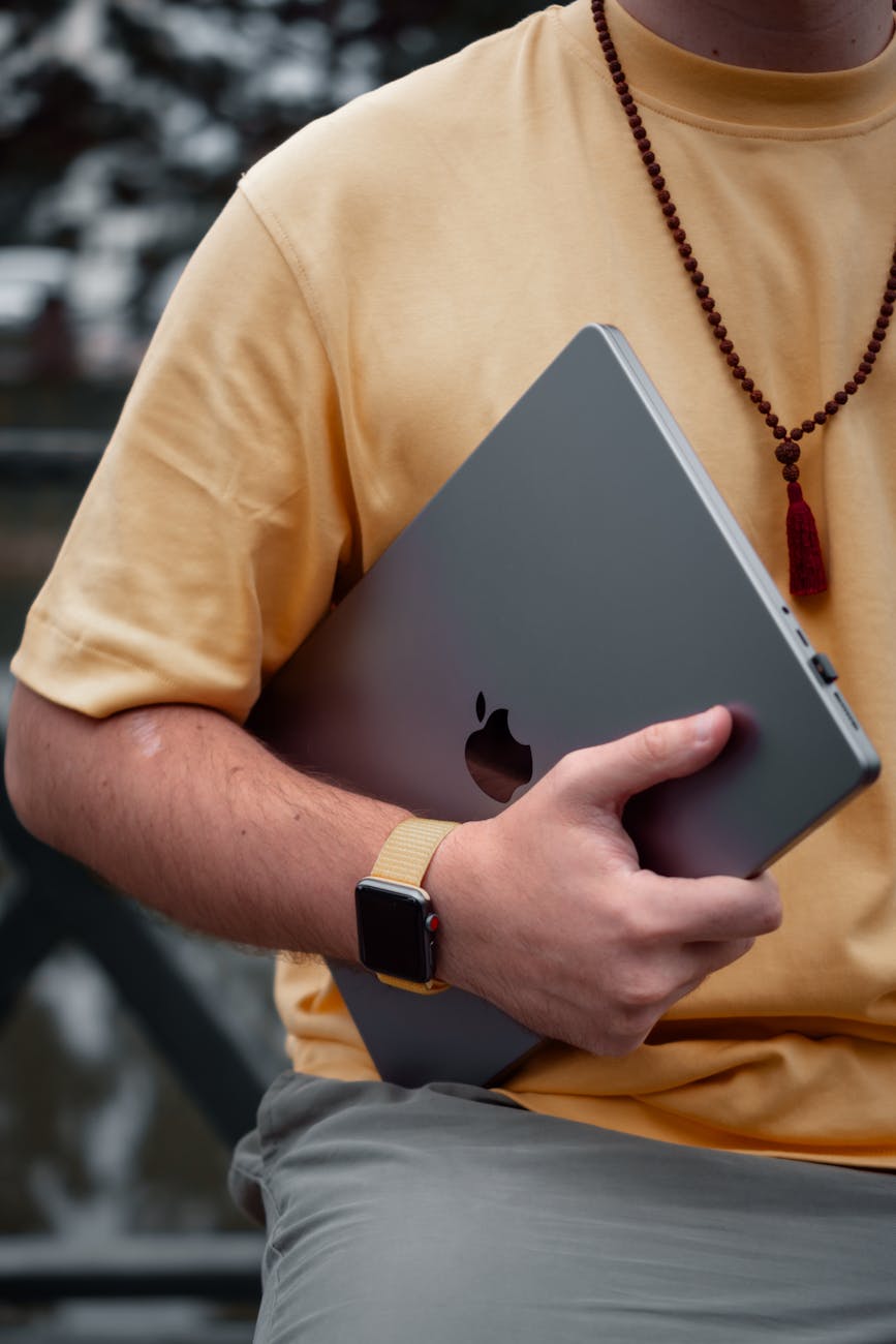 man holding a laptop Technology Gift with a Personal Touch
