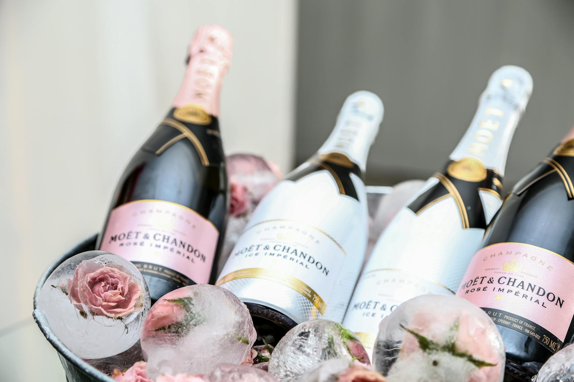 four wine bottles on ice bucket