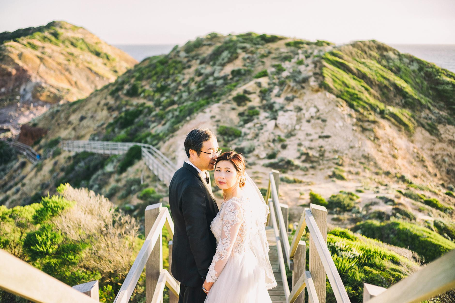 newlywed couple posing in mountains