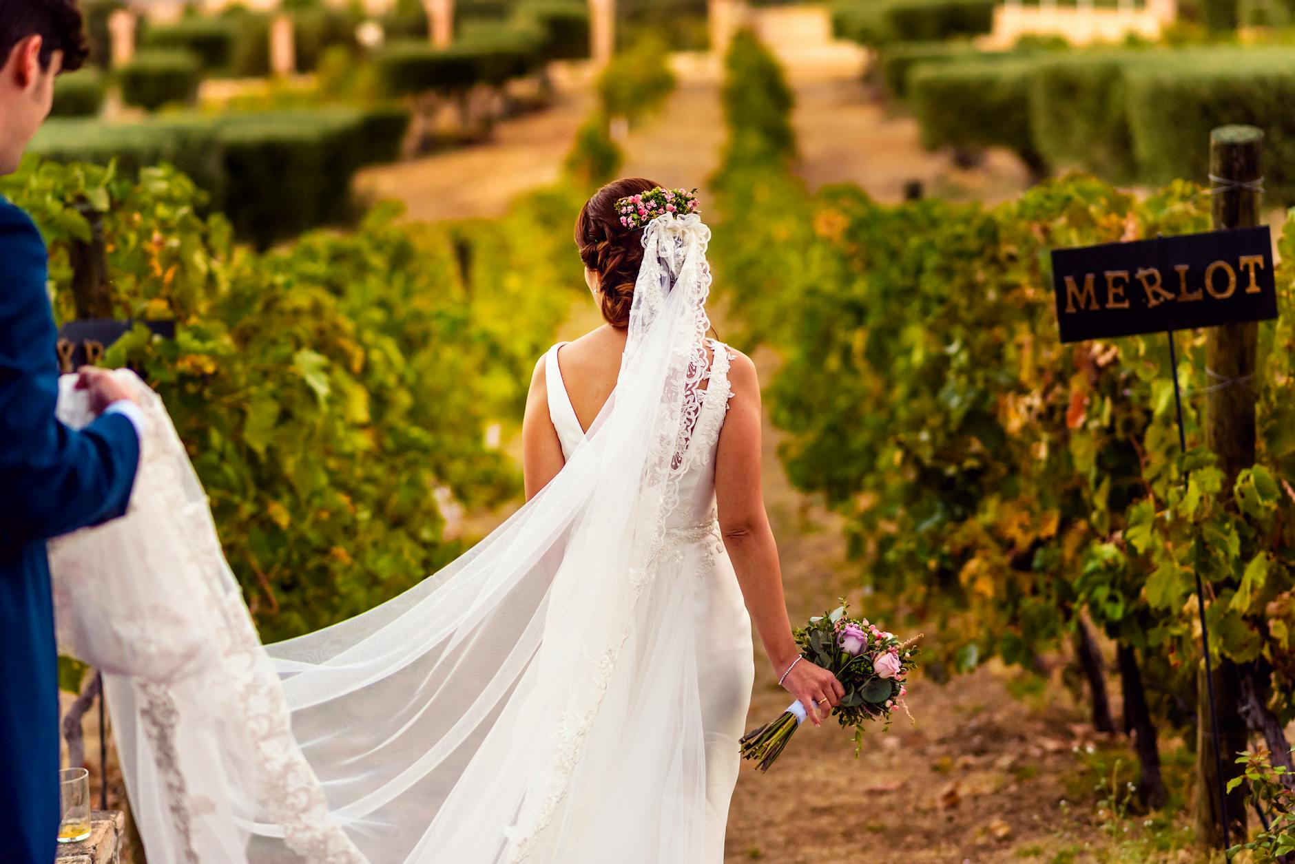 woman in white wedding dress holding bouquet of flowers