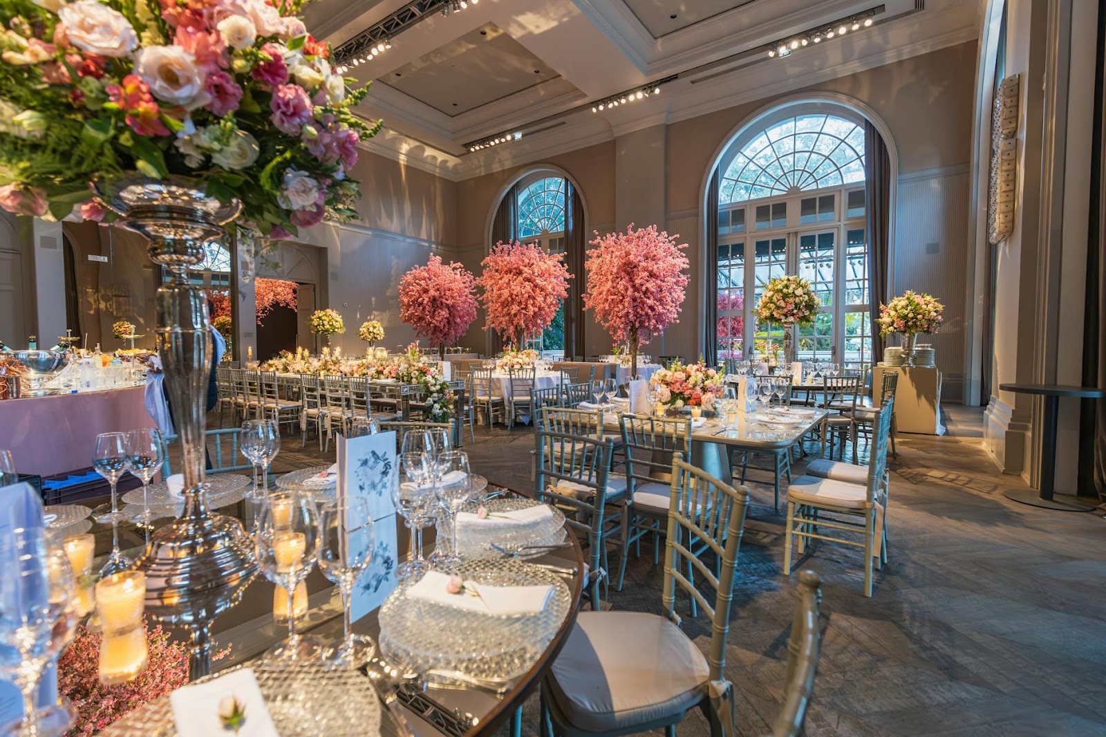 reception venue decorated with colorful trees and flowers