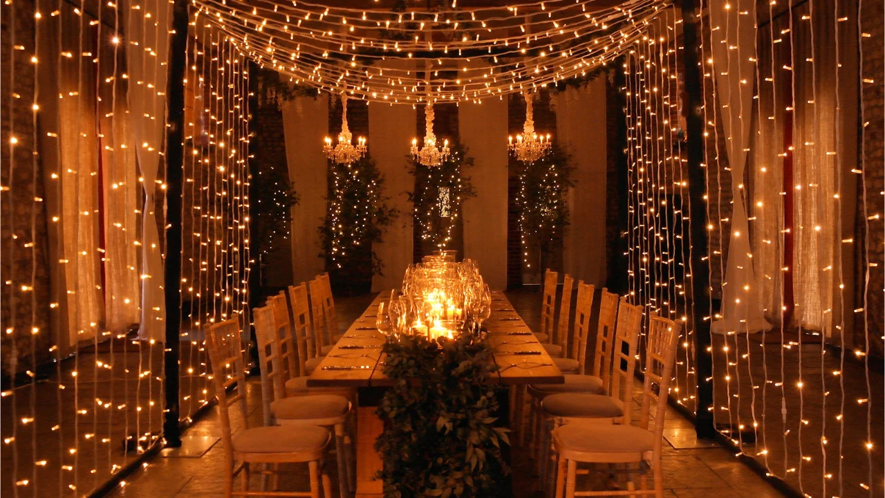 Elegant string lights and whimsical fairy lights create a romantic atmosphere at an outdoor wedding.