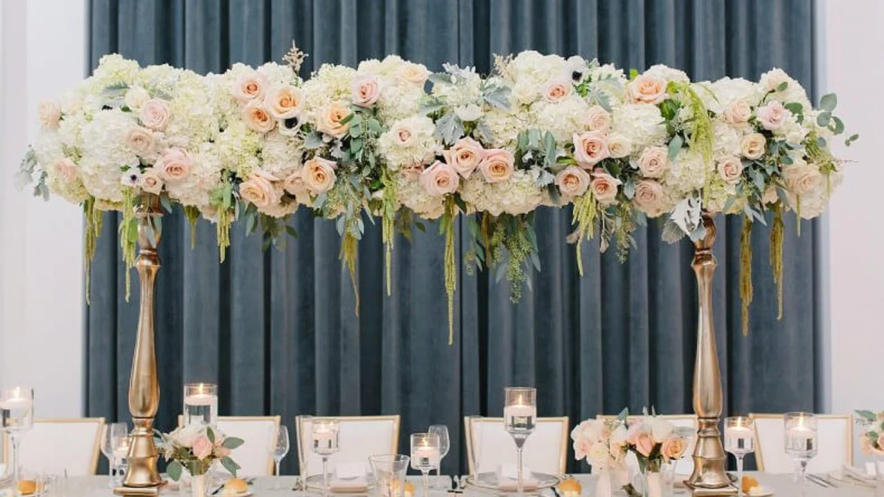 A vibrant Flower arrangements featuring a mix of colorful roses, lilies, and daisies in a decorative vase, artfully arranged with greenery and delicate accents, perfect for home décor or special events.