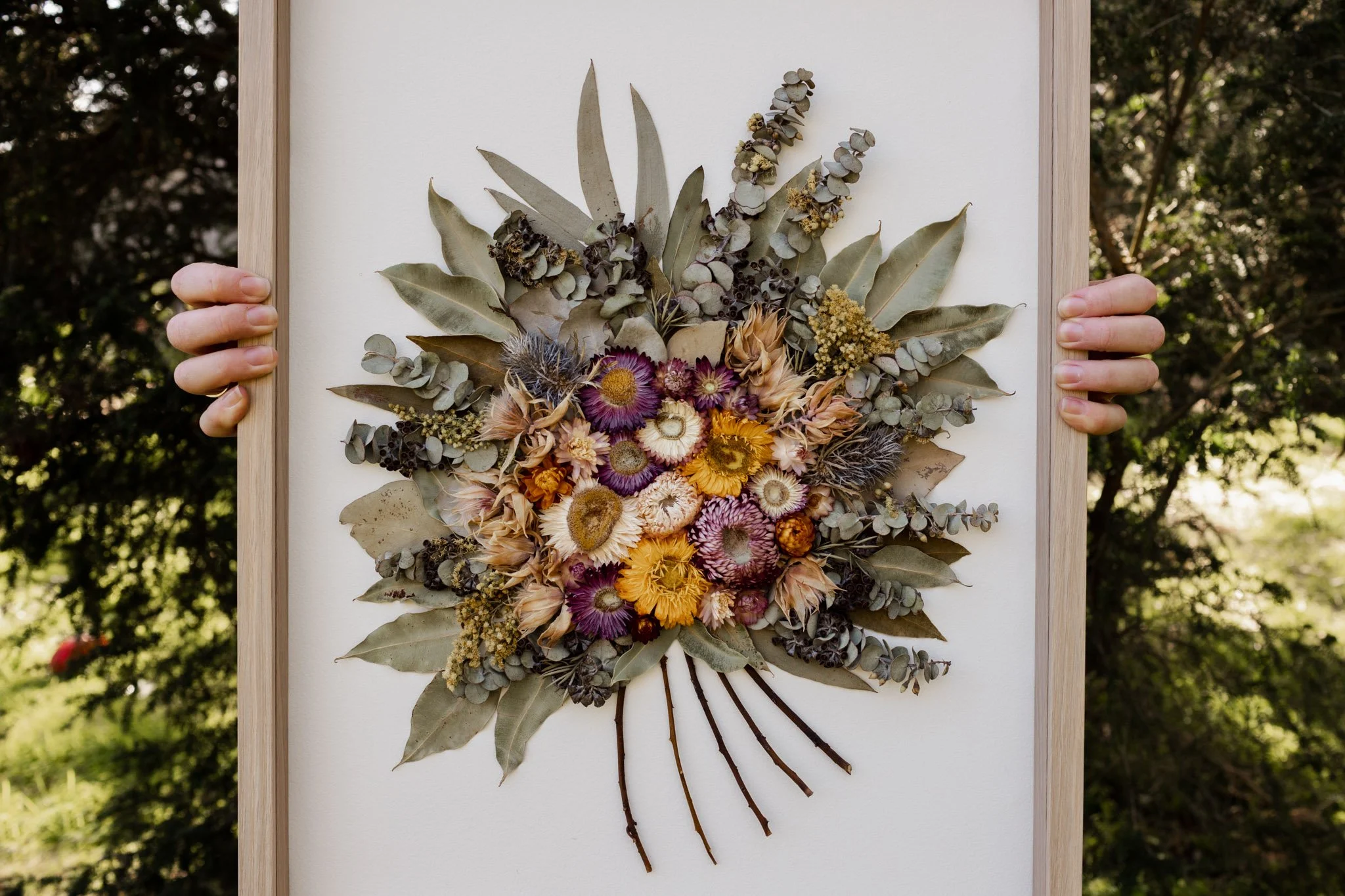 A beautiful botanical art arrangement featuring delicate floral elements and greenery, perfect for incorporating natural elegance into Wedding bouquet preservation ideas
