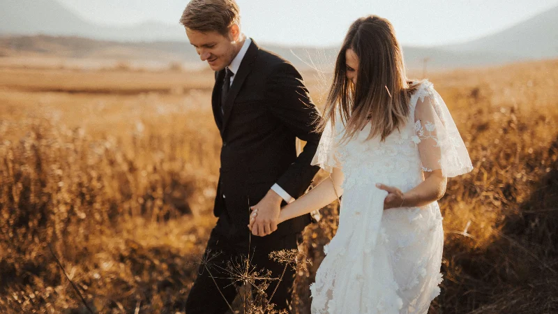 couples holding hand while walking