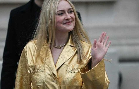 Dakota Fanning Shines in Gold Leather Suit at Chanel Show